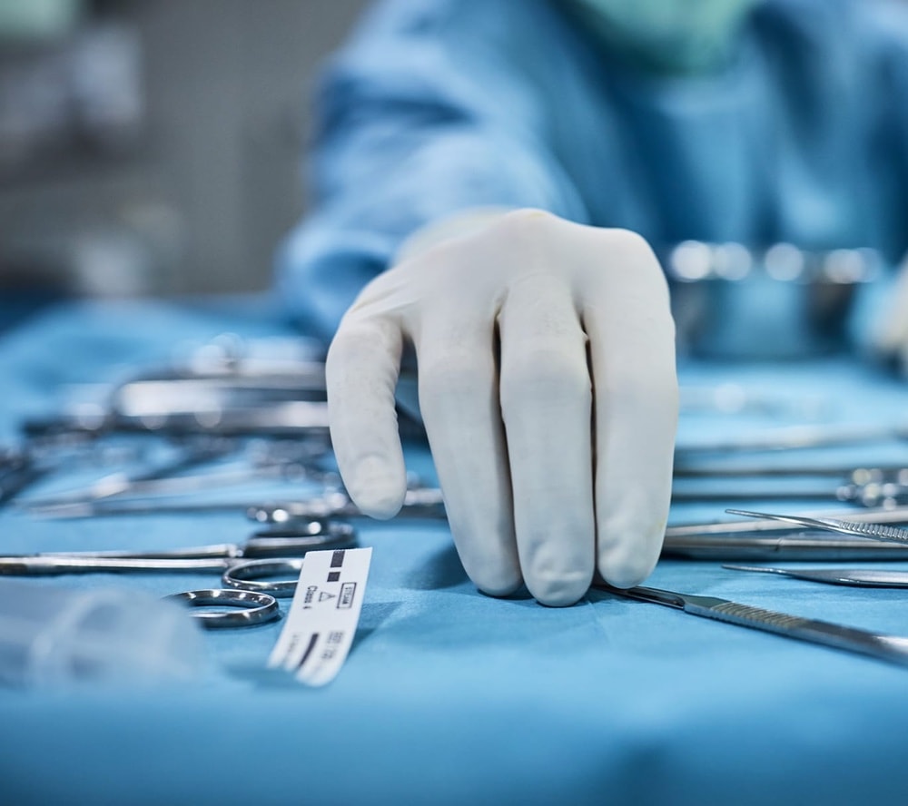 Surgeon's hand reaching for implements